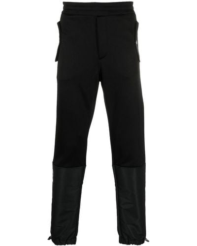 Alexander McQueen Pantalon de jogging fuselé à design à empiècements - Noir