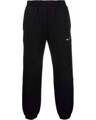 McQ Pantalon de jogging à logo imprimé - Noir