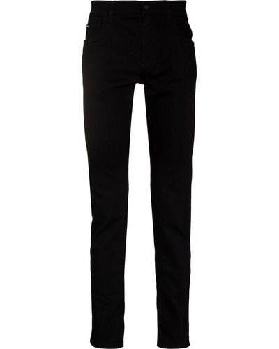 Dolce & Gabbana Vaqueros slim con parche del logo - Negro