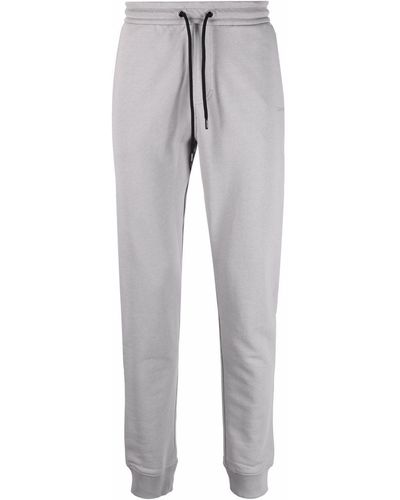Calvin Klein Pantalones de chándal con franjas del logo - Gris