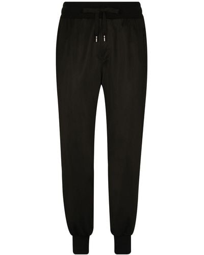 Dolce & Gabbana Pantalones de chándal con franja del logo - Negro