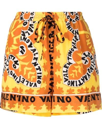 Valentino Garavani Bermudas con logo estampado - Naranja
