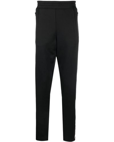 Moschino Pantalones joggers con logo estampado - Negro