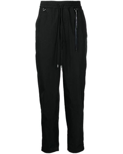 MASTERMIND WORLD Pantalones ajustados con logo estampado - Negro