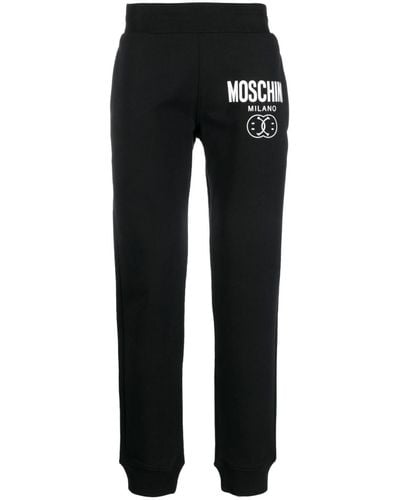 Moschino Pantalon de jogging en coton à logo imprimé - Noir