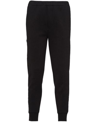 Prada Pantalon de jogging fuselé à patch logo - Noir