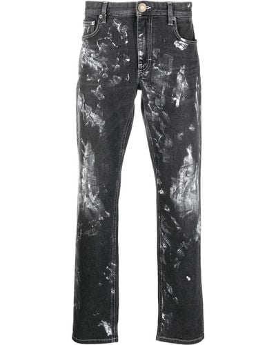 Roberto Cavalli Distressed-Jeans mit Logo-Print - Schwarz