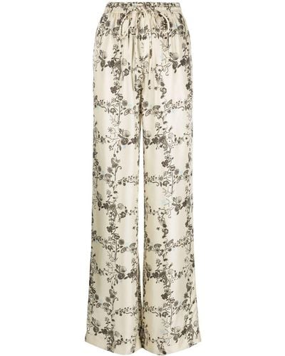 Nanushka Pantalon ample en soie à fleurs - Neutre