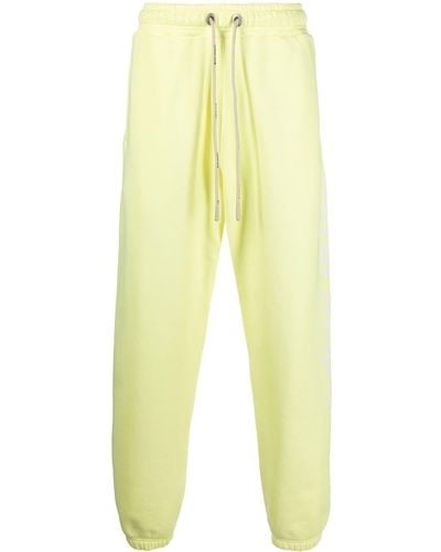 Palm Angels Pantalones de chándal con logo estampado - Amarillo