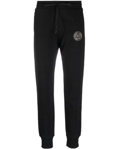 Versace Pantalones de chándal con logo estampado - Negro