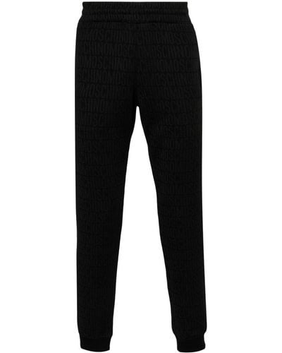 Moschino Pantalones de chándal con logo en jacquard - Negro