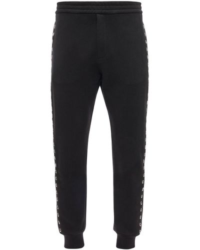 Alexander McQueen Pantalones de chándal con ojales - Negro