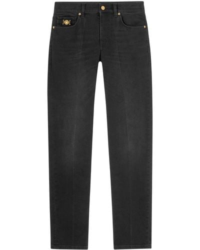 Versace Halbhohe Slim-Fit-Jeans mit Medusa Head-Verzierung - Schwarz