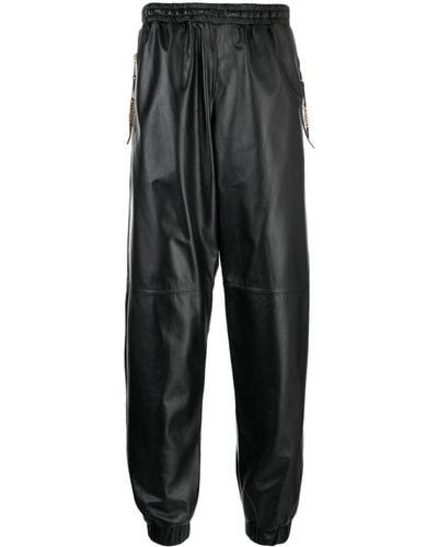 Moschino Pantalon de jogging court en cuir - Noir