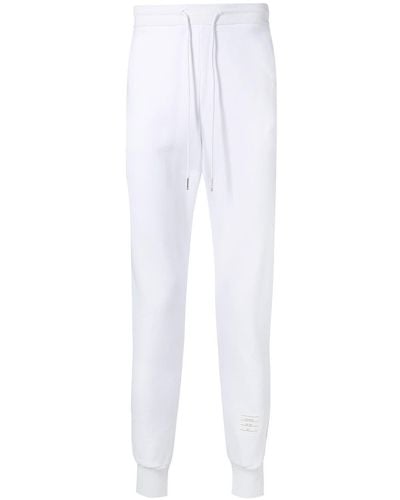 Thom Browne Pantalones de chándal con rayas del logo - Blanco