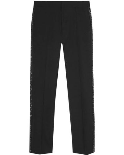 Versace Pantalones ajustados con aplique del logo - Negro