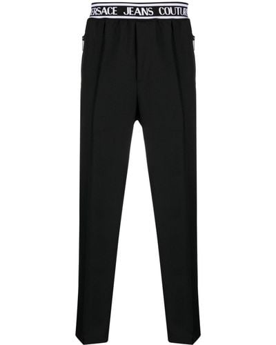 Versace Pantaloni slim con banda logo - Nero
