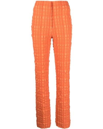 Nanushka Pantalones de tejido seersucker Juna - Naranja