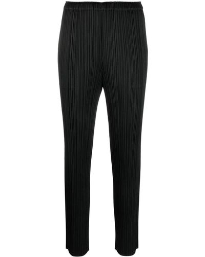 Pleats Please Issey Miyake Pantalon fuselé court à design plissé - Noir