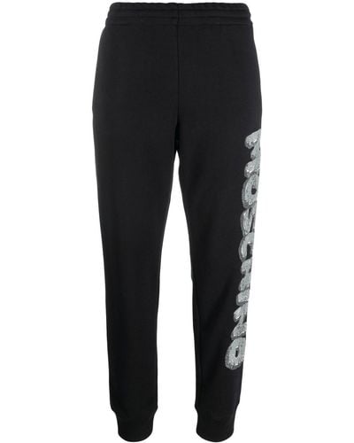 Moschino Pantalones joggers con logo estampado - Negro