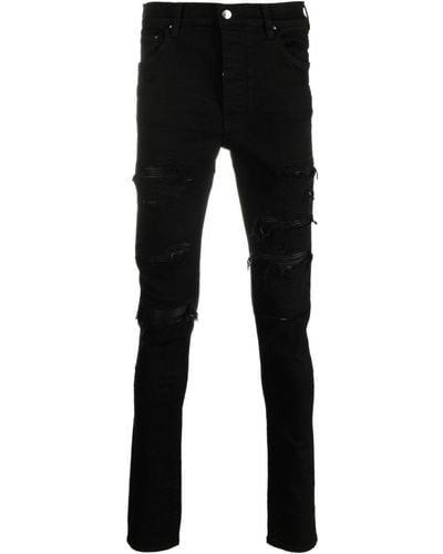 Amiri Skinny-Jeans mit Logo-Patch - Schwarz