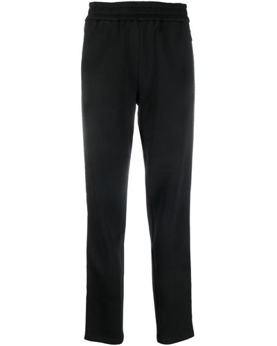 Emporio Armani Pantalones de chándal con franja del logo - Negro