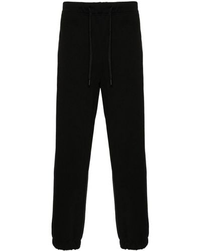 Versace Pantalones de chándal con franjas del logo - Negro