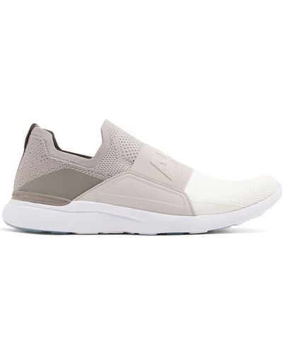 Athletic Propulsion Labs Sneakers senza lacci con logo goffrato - Bianco
