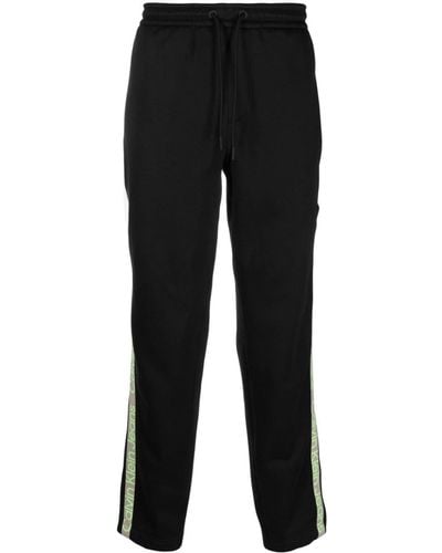 Calvin Klein Pantalones de chándal con franja del logo - Negro