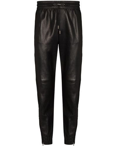 Saint Laurent Pantalones de chándal tapered con cremallera - Negro