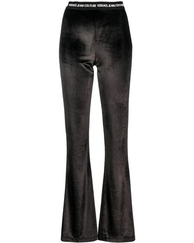 Versace Pantalon évasé à taille à logo - Noir