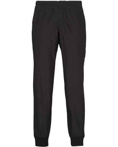 Prada Pantalon de jogging en soie à patch logo - Noir