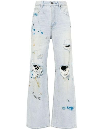 DOMREBEL Scuff Bootcut Jeans mit Farbklecksen - Blau