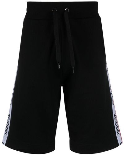 Moschino Pantalones cortos de chándal con franjas del logo - Negro