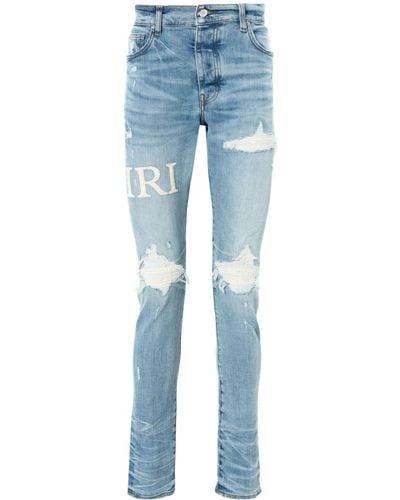 Amiri MX1 bouclé-logo skinny jeans - Blau