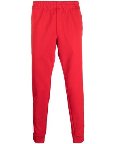 adidas Pantalones de chándal con logo bordado - Rojo
