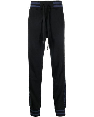 Versace Pantalones de chándal con franjas del logo - Negro