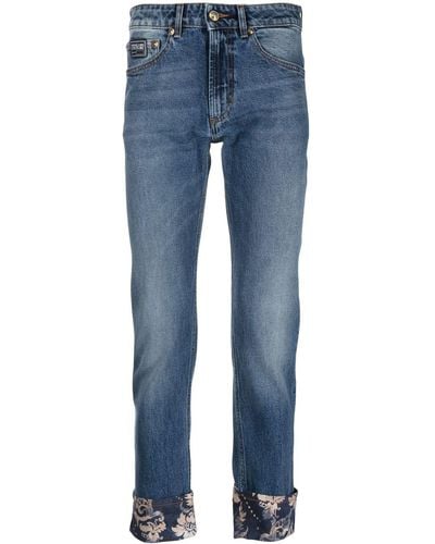 Versace Cropped-Jeans mit Blumen-Print - Blau
