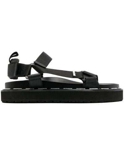 Moschino Sandalias con tira trasera y logo - Negro