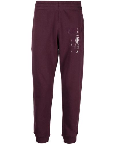 Moschino Pantalon de jogging en coton à logo imprimé - Violet