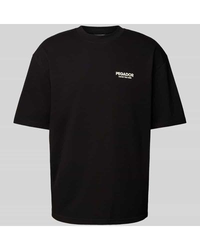 PEGADOR Oversized T-Shirt mit Label- und Statement-Print Modell 'BALDOCK' - Schwarz