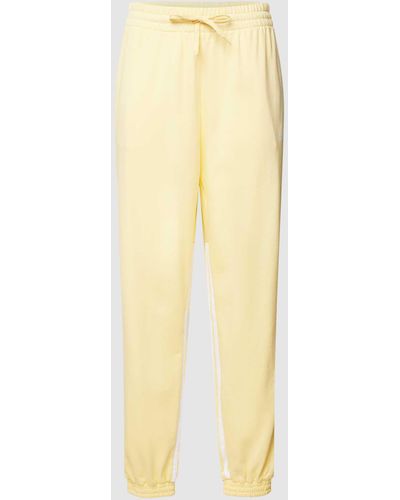 adidas Sweatpants mit seitlichem Reißverschluss - Gelb