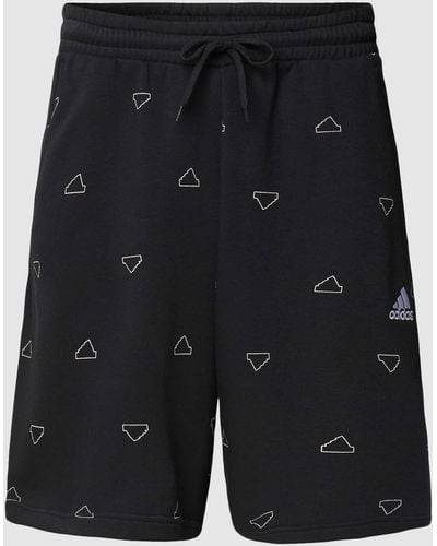 adidas Shorts mit Allover-Label-Print - Schwarz