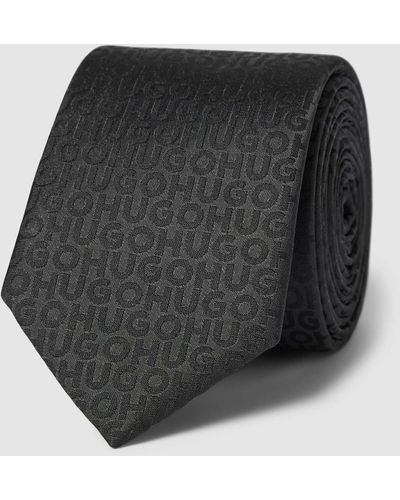 HUGO Krawatte mit Allover-Label-Muster - Schwarz