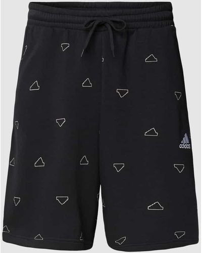 adidas Shorts mit Allover-Label-Print - Schwarz