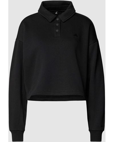 adidas Cropped Sweatshirt mit rückseitigem Label-Print - Schwarz
