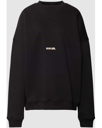 Karo Kauer Oversized Sweatshirt mit Label-Stitching Modell 'Sold Out' - Schwarz