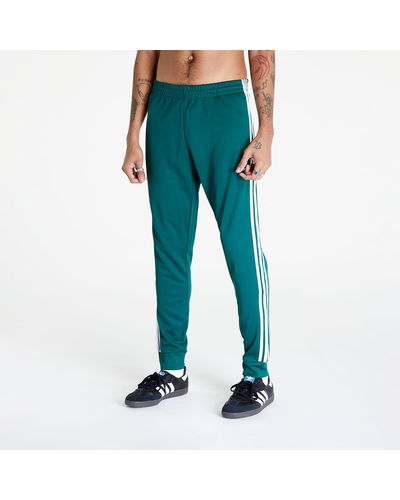 Adidas sst track pants noble green hotsell