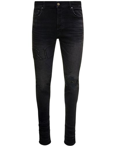Amiri Jeans skinny con logo in strass e effetto used in denim di cotone stretch - Nero