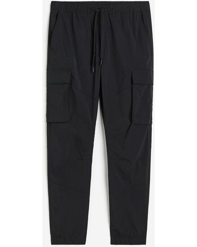 H&M Pantalon jogger cargo Slim Fit en nylon - Noir